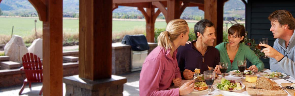 outdoor dining under timber framed attached pergolas