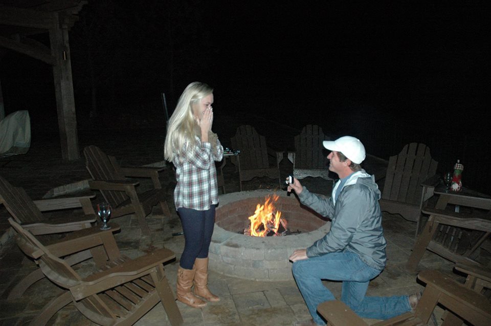 Couple marriage proposal by a fire pit