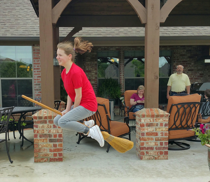 family playing under outdoor gazebo kitchen