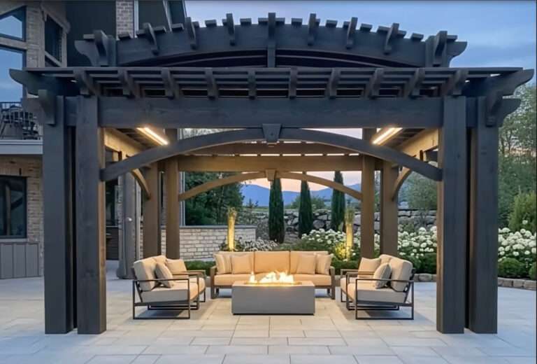 Barrel roof timber frame pergola with curved beams and fire table seating at dusk