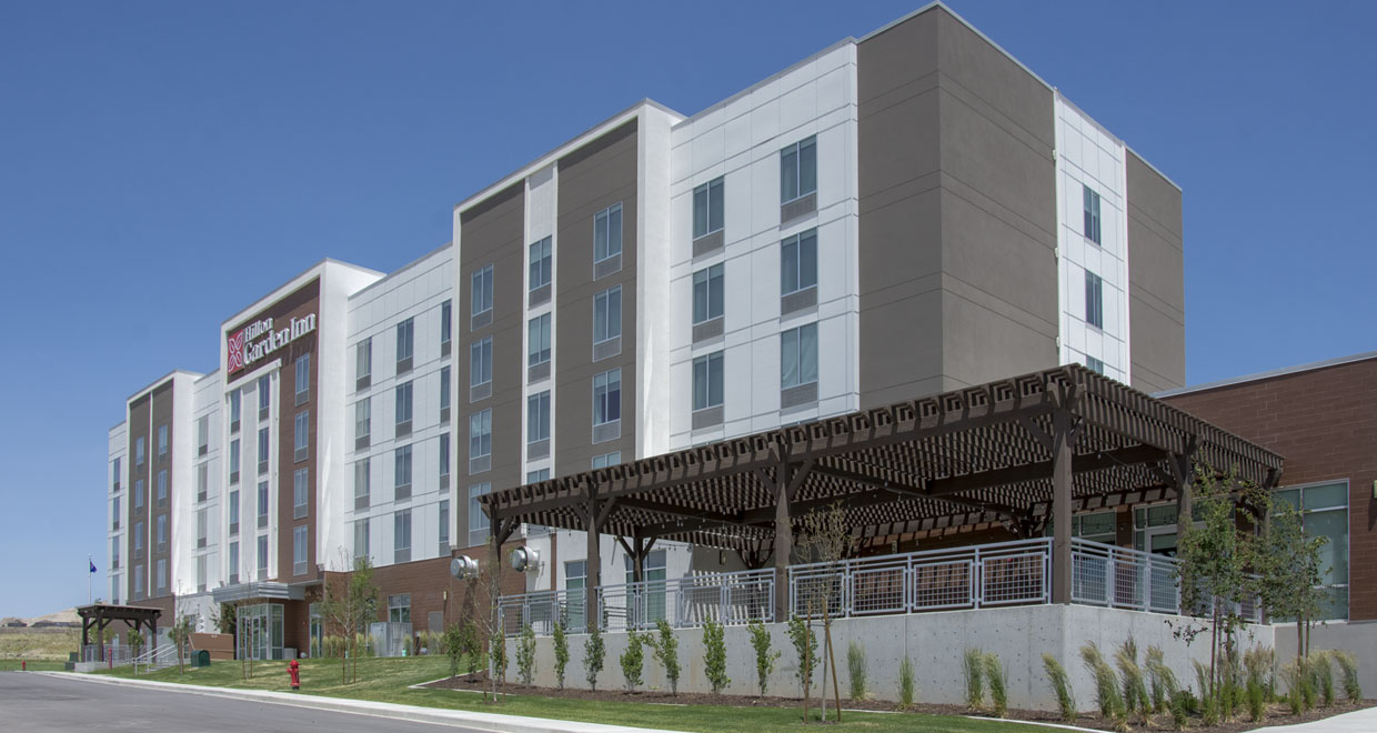 Timber pergola built by Western Timber Frame® outside the Hilton Garden Inn, enhancing the hotel's outdoor guest space with shade and architectural appeal.