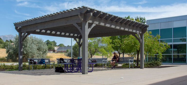 Commercial mass timber pergola providing shade on campus grounds