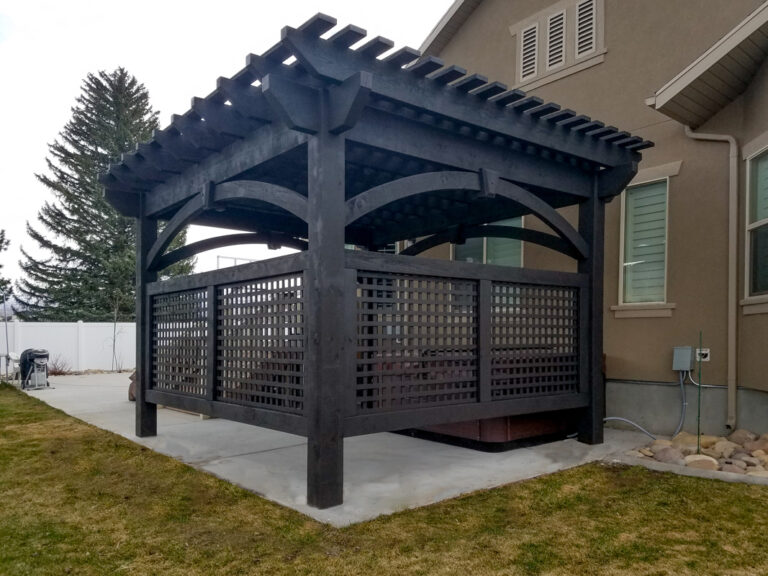 Pergola with a lattice wall, creating a private space in the backyard.