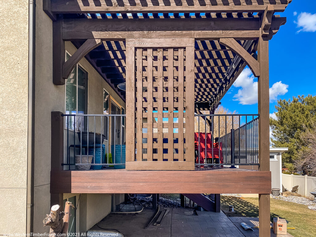 Western Timber Frame™ timber frame pergola and deck featuring a latticed privacy screen that doubles as a windbreak and provides targeted shade.