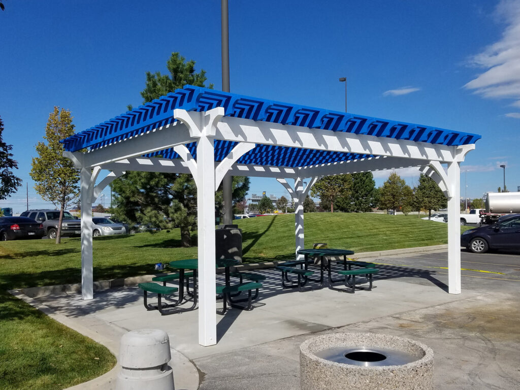 Commercial pergola with custom blue and white stain over picnic area