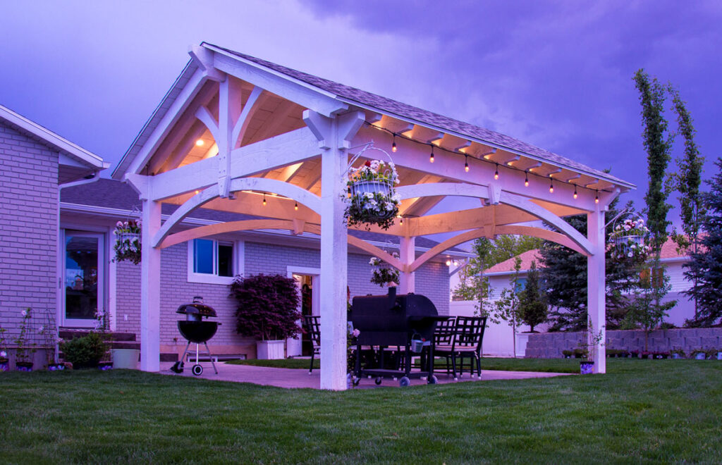 White Western Timber Frame pavilion with soft lighting, showcasing elegant timber frame roof design.