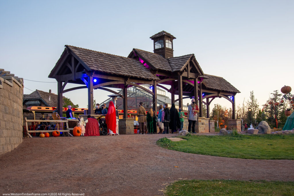 Three timber frame pavilions with integrated power and cupola, designed for a theme park train station by Western Timber Frame