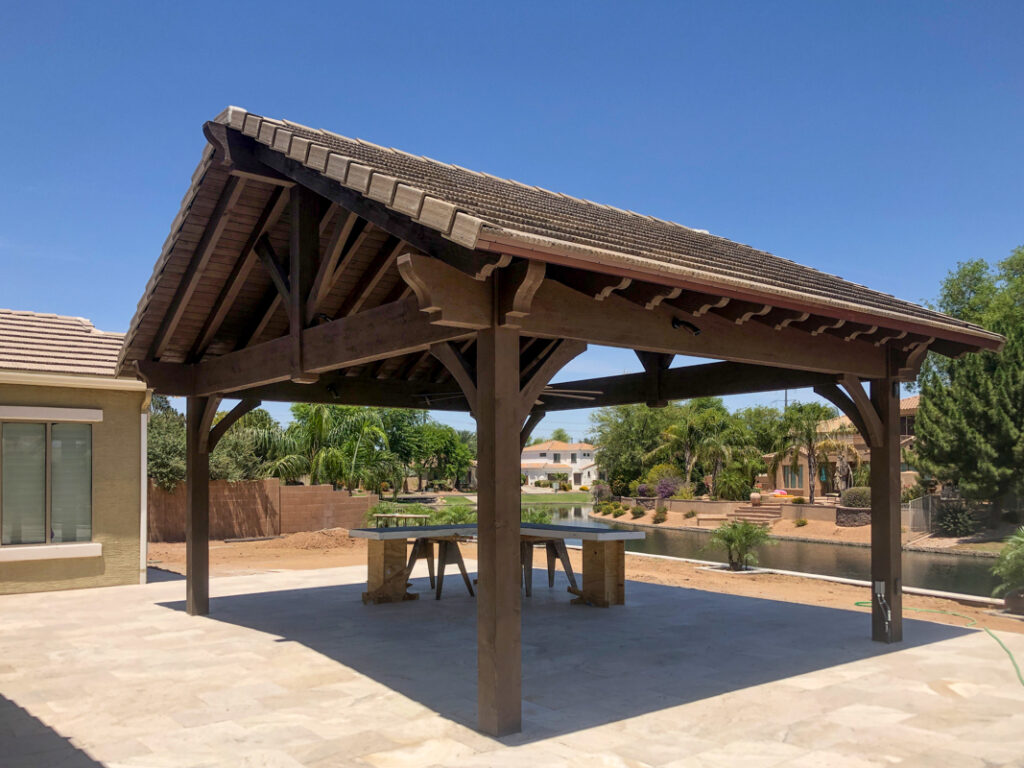 Timber frame pavilion with Southwest-style clay barrel roof tiles by Western Timber Frame