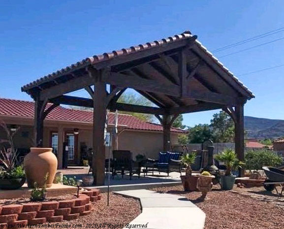 Timber frame pavilion with Southwest-style clay barrel roof tiles by Western Timber Frame
