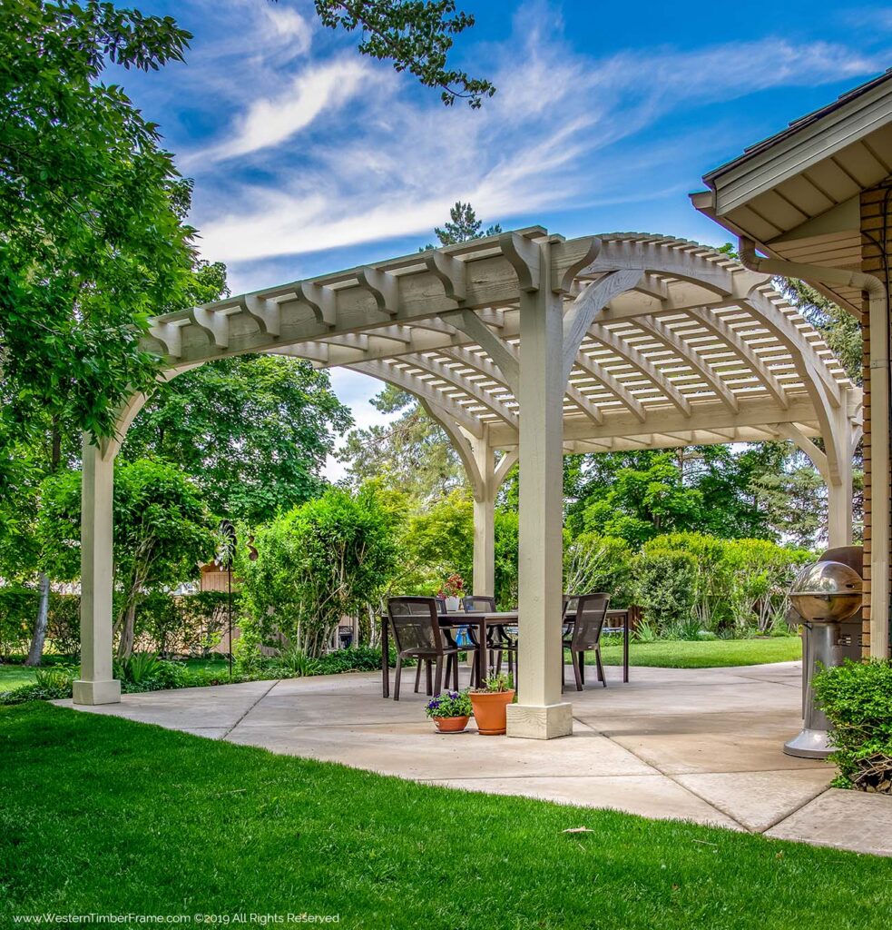 White timber frame pergola with barrel-arched roof by Western Timber Frame