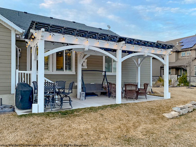 White timber frame pergola with black ebony roof by Western Timber Frame