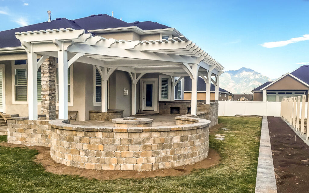Timber frame pergola with inverted radius roof design curving around a fire pit by Western Timber Frame