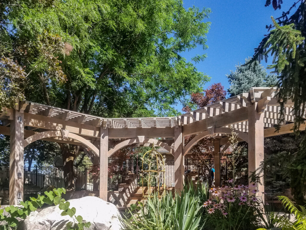 Timber frame pergola with inverted radius roof design by Western Timber Frame