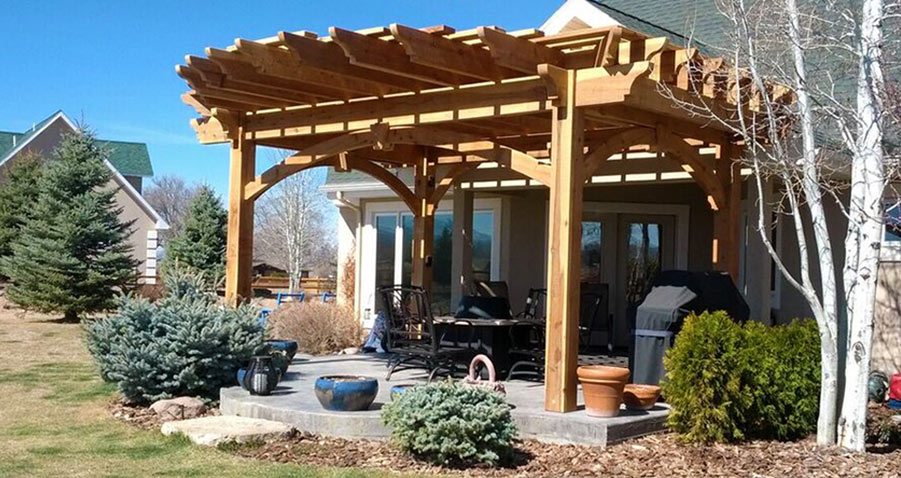 Timber frame pergola with curved half-round cantilevered roof by Western Timber Frame