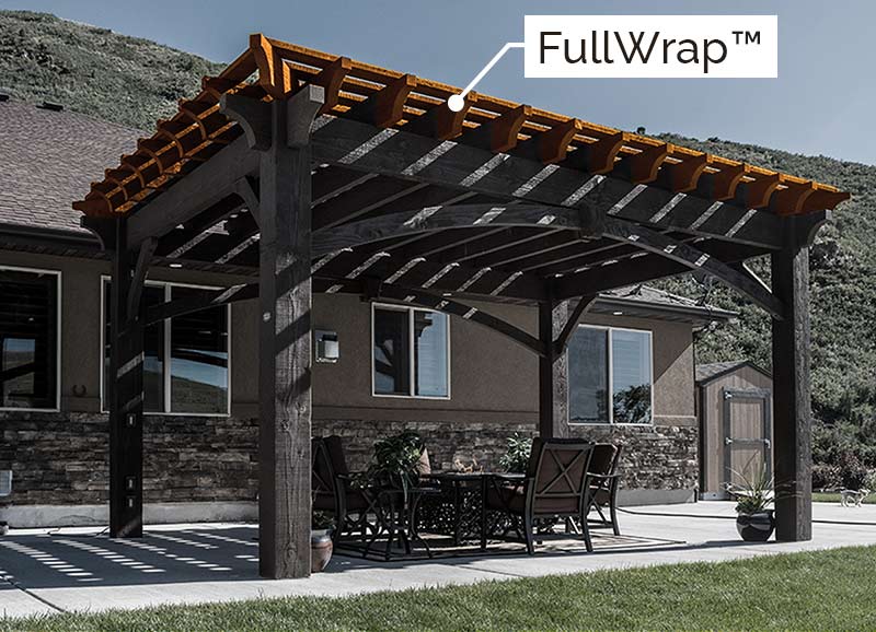 Timber frame pergola with FullWrap® roof showcasing decorative profile beam ends on all sides by Western Timber Frame