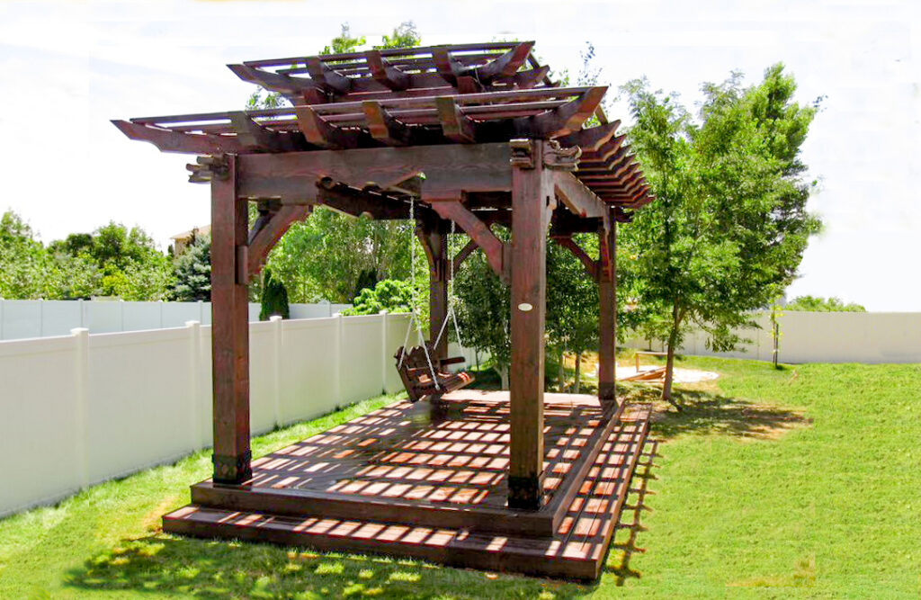 Western Timber Frame Asian-style tiered roof pergola with carved wood dragon heads on each corner.