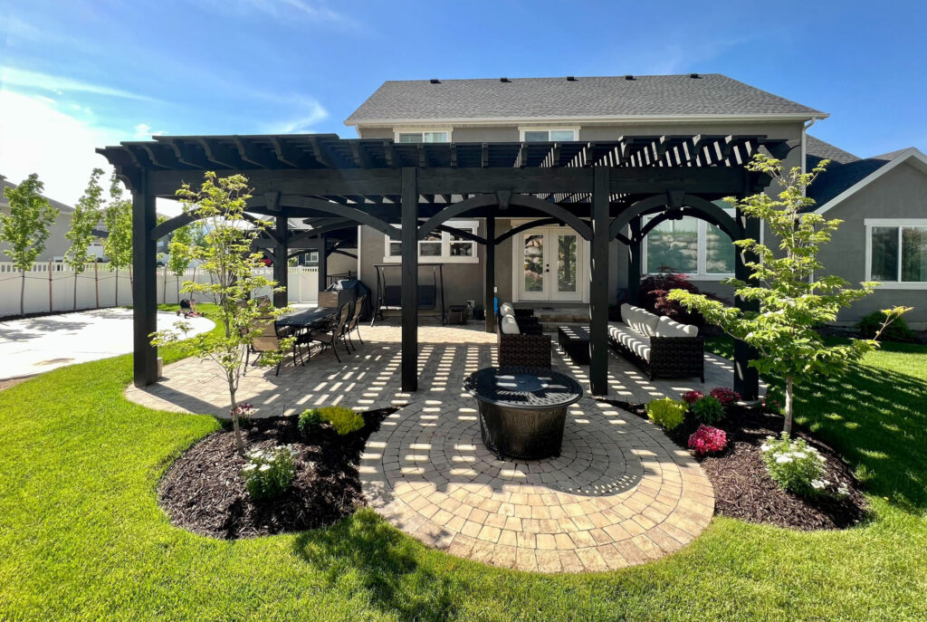 Ebony-Stained Pergola Over Curved Backyard Patio