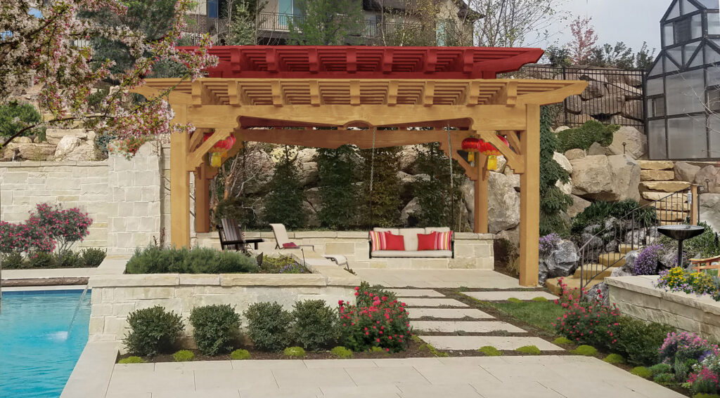 Custom-stained timber pergola with red top beams and Asian-inspired garden setting