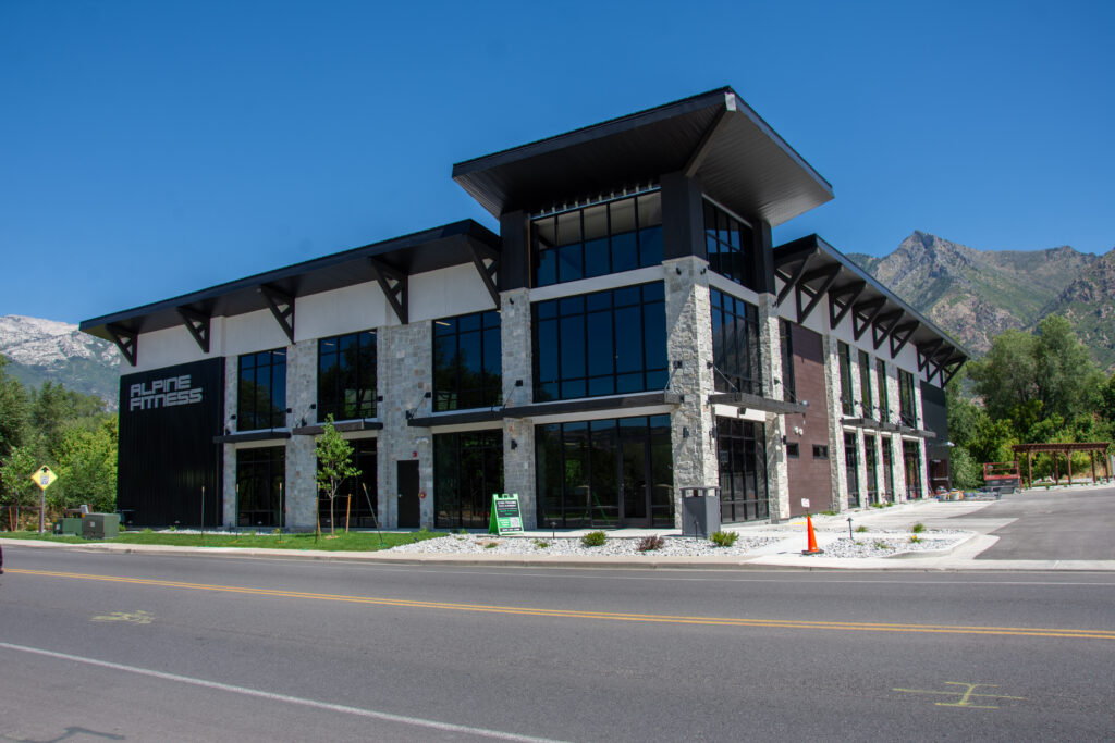 Western Timber Frame™ black timber elements on the exterior of Alpine Fitness, featuring modern architectural detailing across the gables, overhangs, and structural brackets
