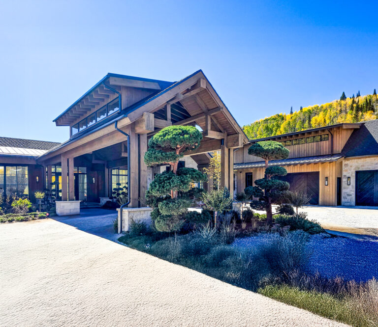 Commercial timber frame porte-cochère and exterior designed by Western Timber Frame™, featuring large exposed beams, precision joinery, and a warm wood finish that enhances the entrance of a hospitality or business space.