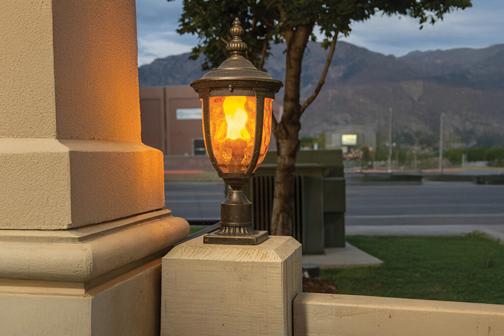 Classic lamp post illuminated on a TimberVolt® powered pillar at sunset