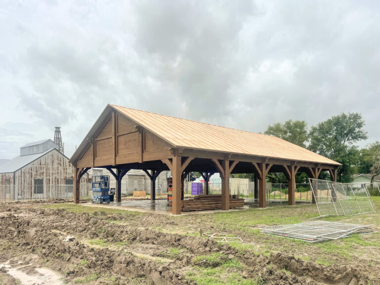 Timber pavilion installation at Lamar University by Western Timber Frame during wet weather conditions.