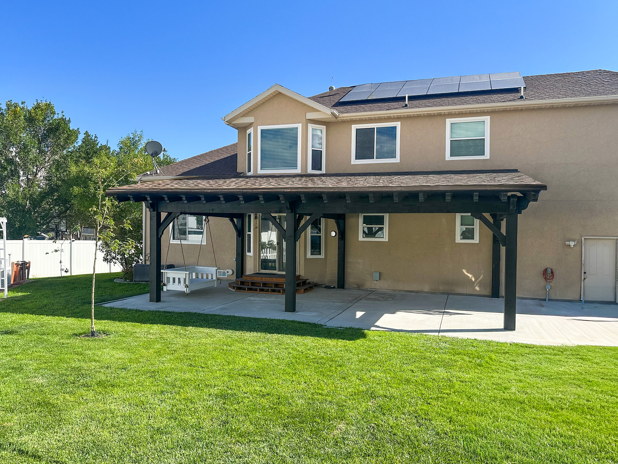 Black timber frame covered patio with solid roof