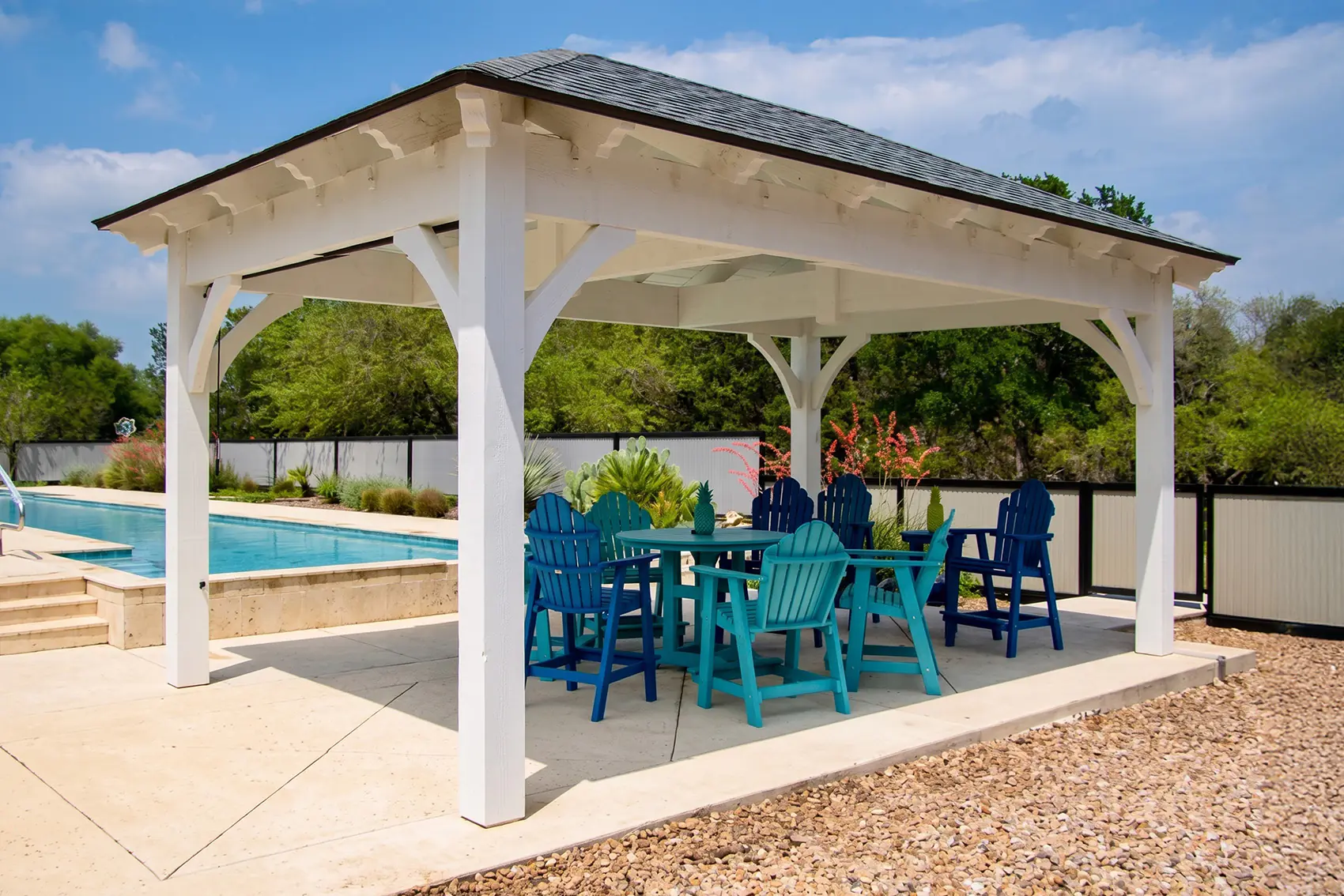 white DIY pavilion kit installed in Texas backyard next to pool with outdoor seating