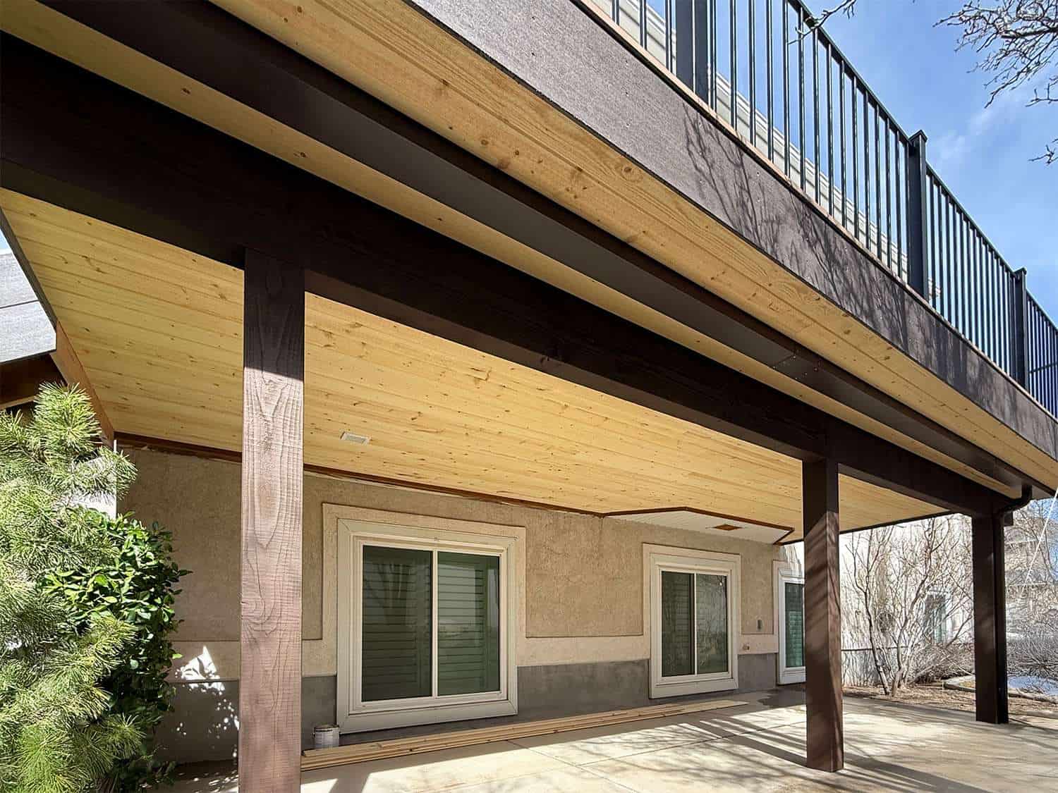 Timber frame deck ceiling with tongue and groove pine planking and stained beams