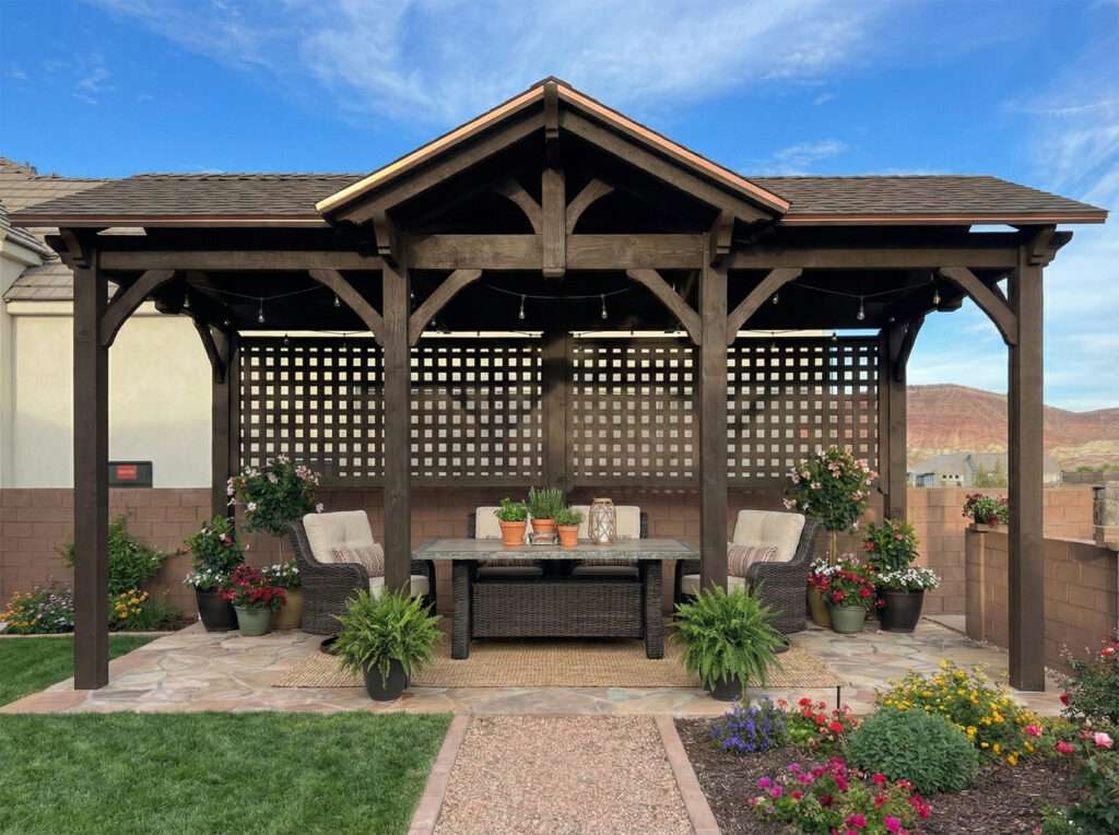 timber frame backyard pavilion with lattice privacy wall and outdoor seating area